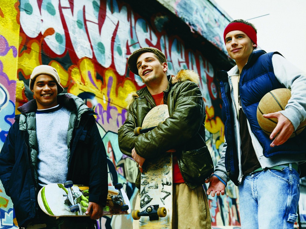 Teenage Boys Standing in an Urban Backstreet Holding Skateboards and a Basketball